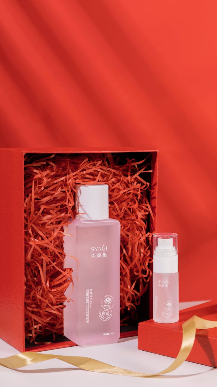 Elegant skincare serum bottles on a vibrant red background. Perfect for beauty and cosmetics promotions.
