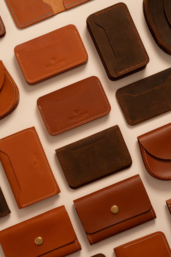 Elegant assortment of handcrafted brown leather wallets in a flat lay display.